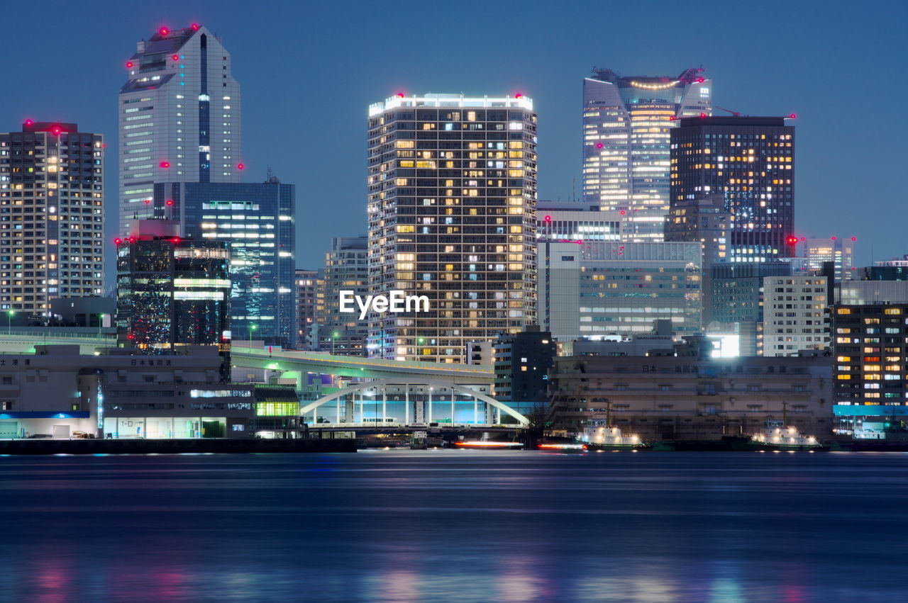 Illuminated buildings against sky at night