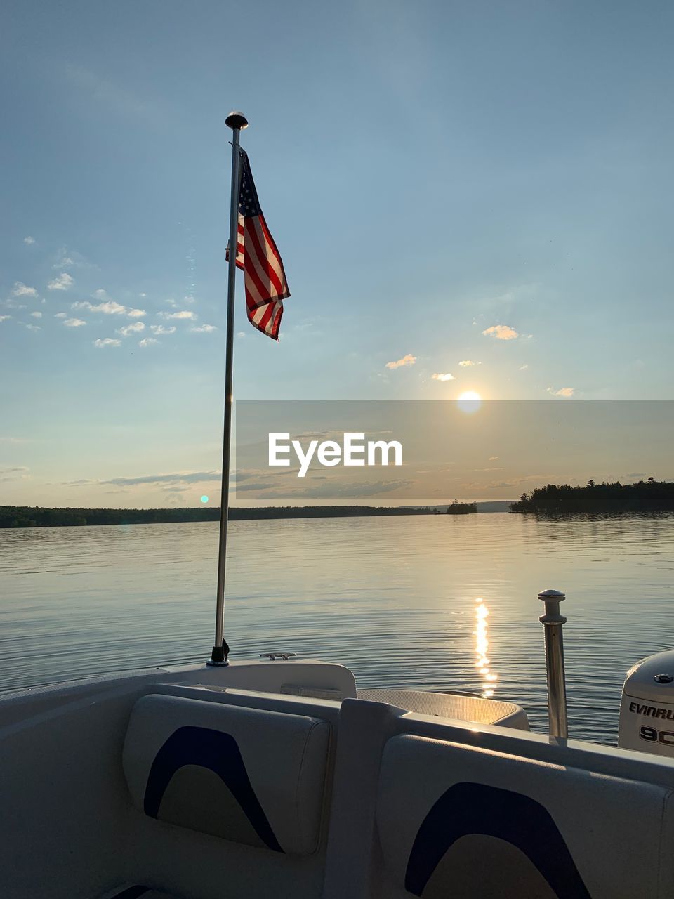 FLAG AGAINST SKY AT SUNSET