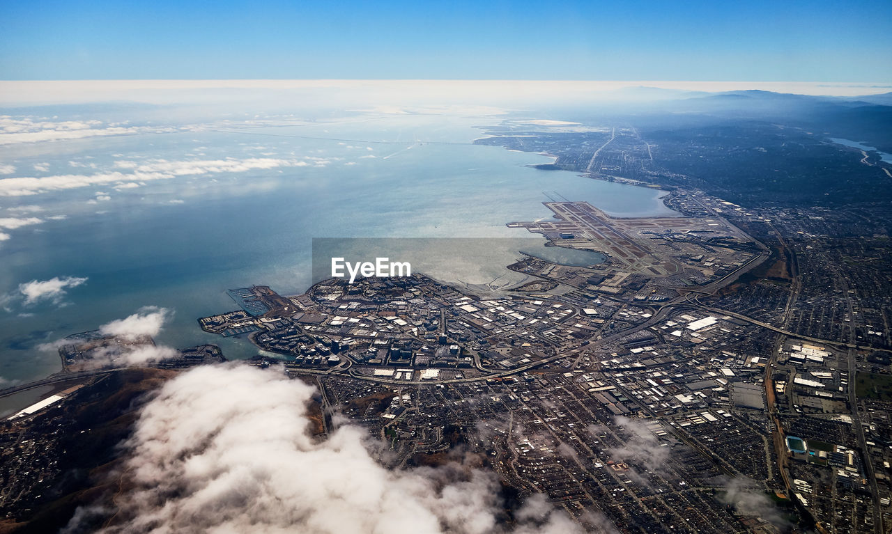 High angle view of sea and buildings against sky