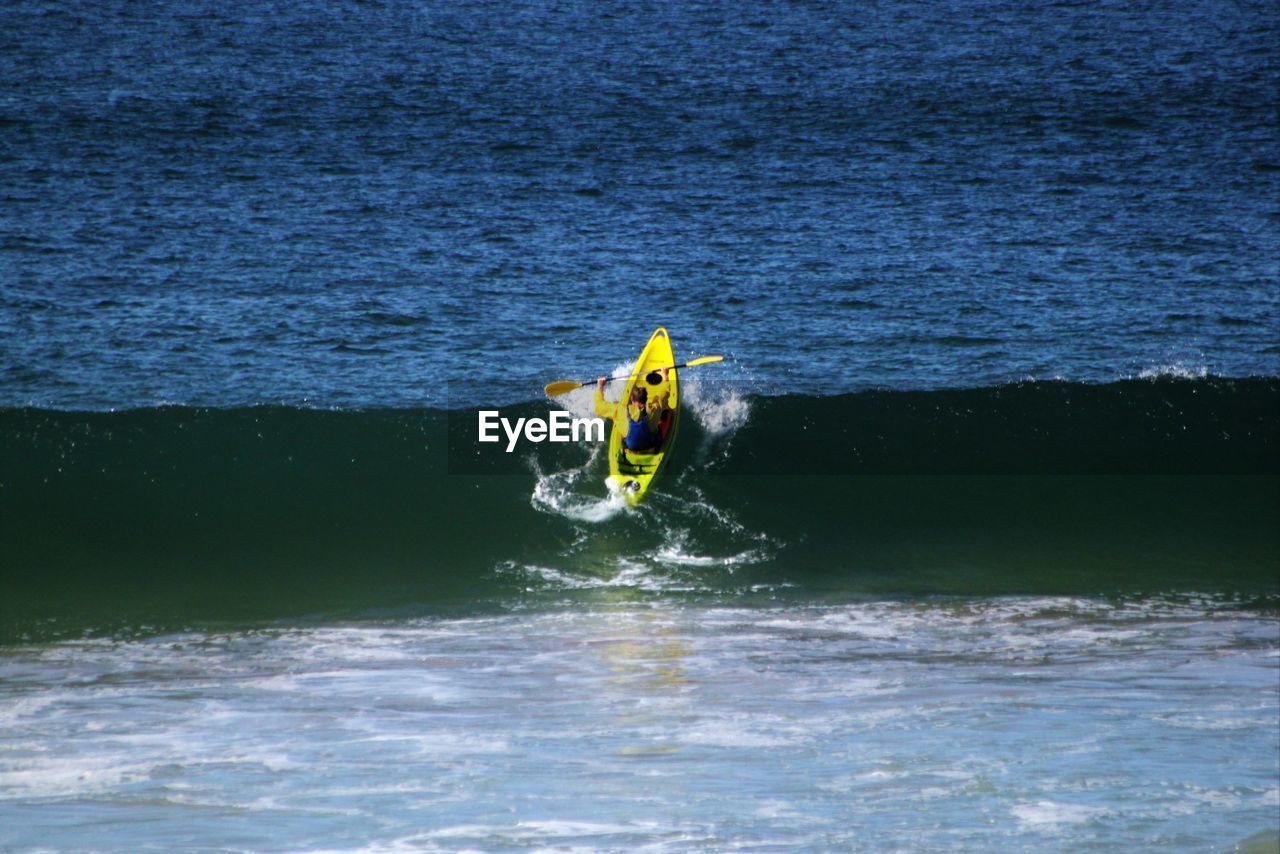 Man kayaking on sea