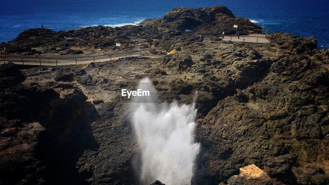 VIEW OF WATERFALL AGAINST SKY