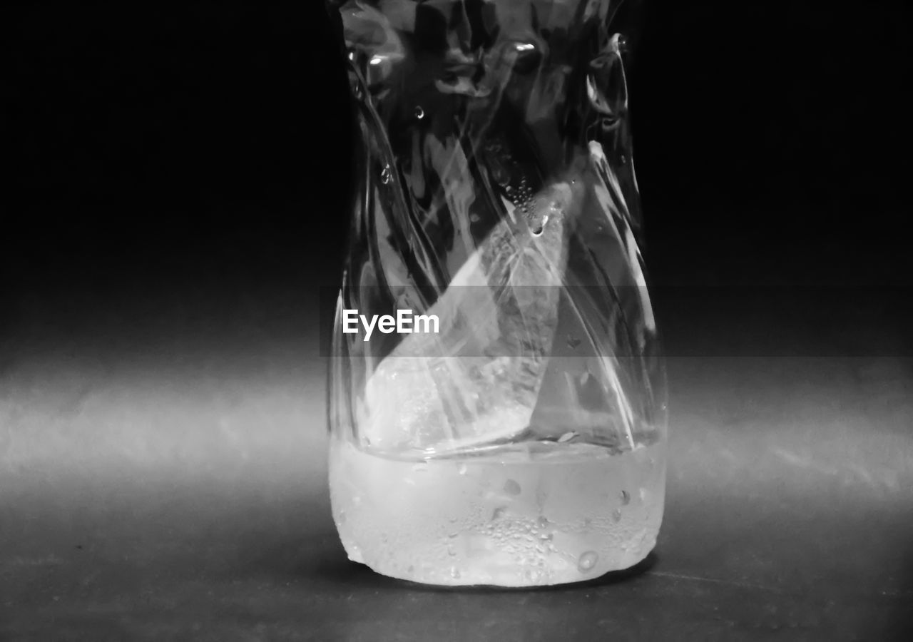 Close-up of water bottle against black background