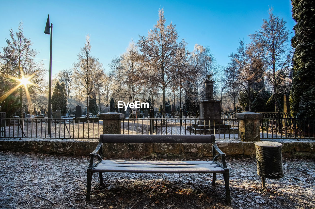 Bench against graveyard during winter 