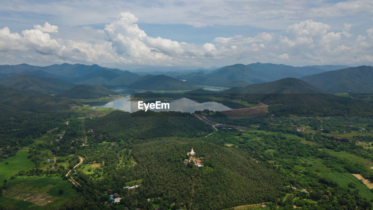 Scenic view of field and mountains against sky