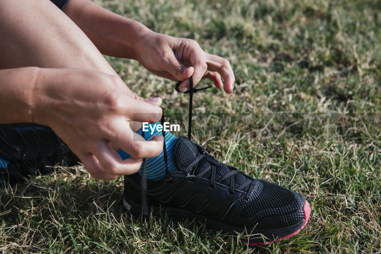 Girl hands tying running shoelaces