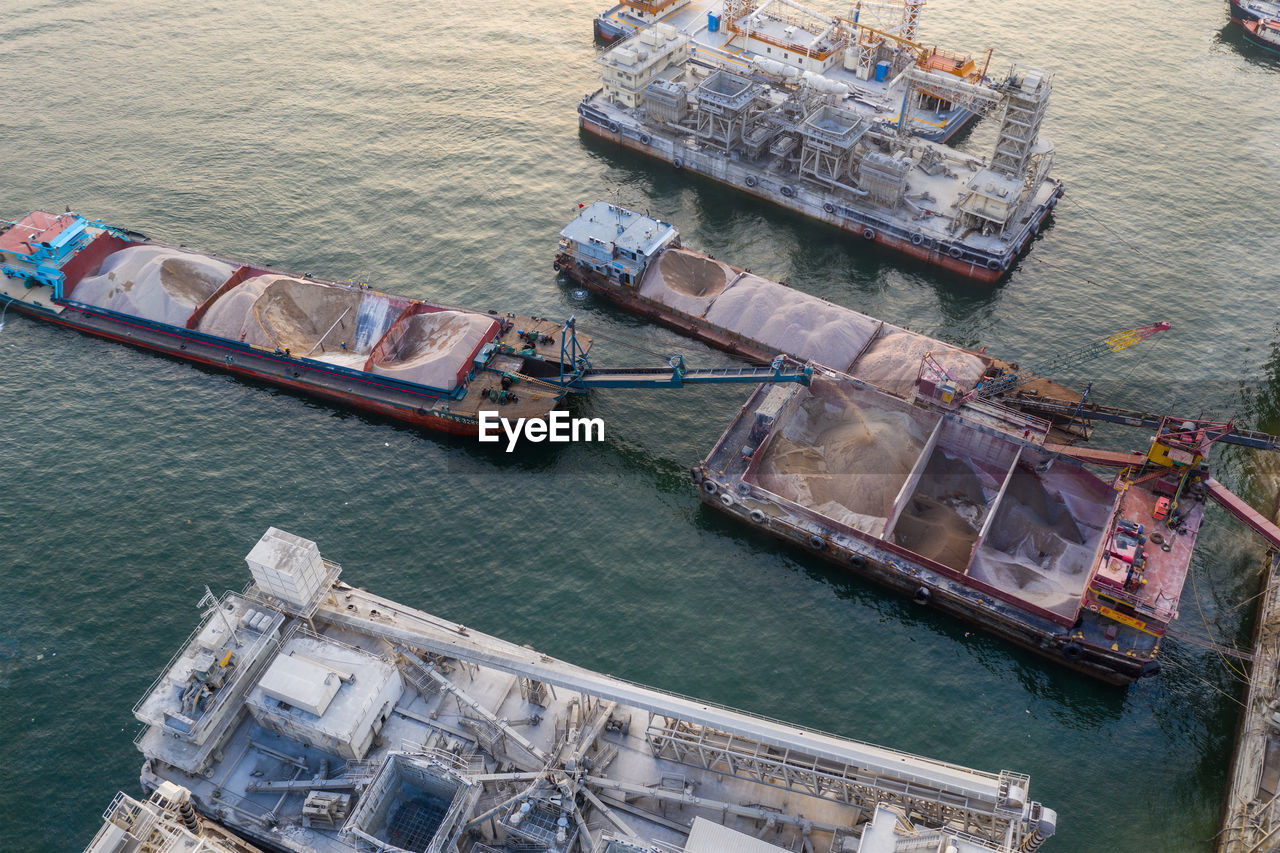 HIGH ANGLE VIEW OF BOATS MOORED AT PORT