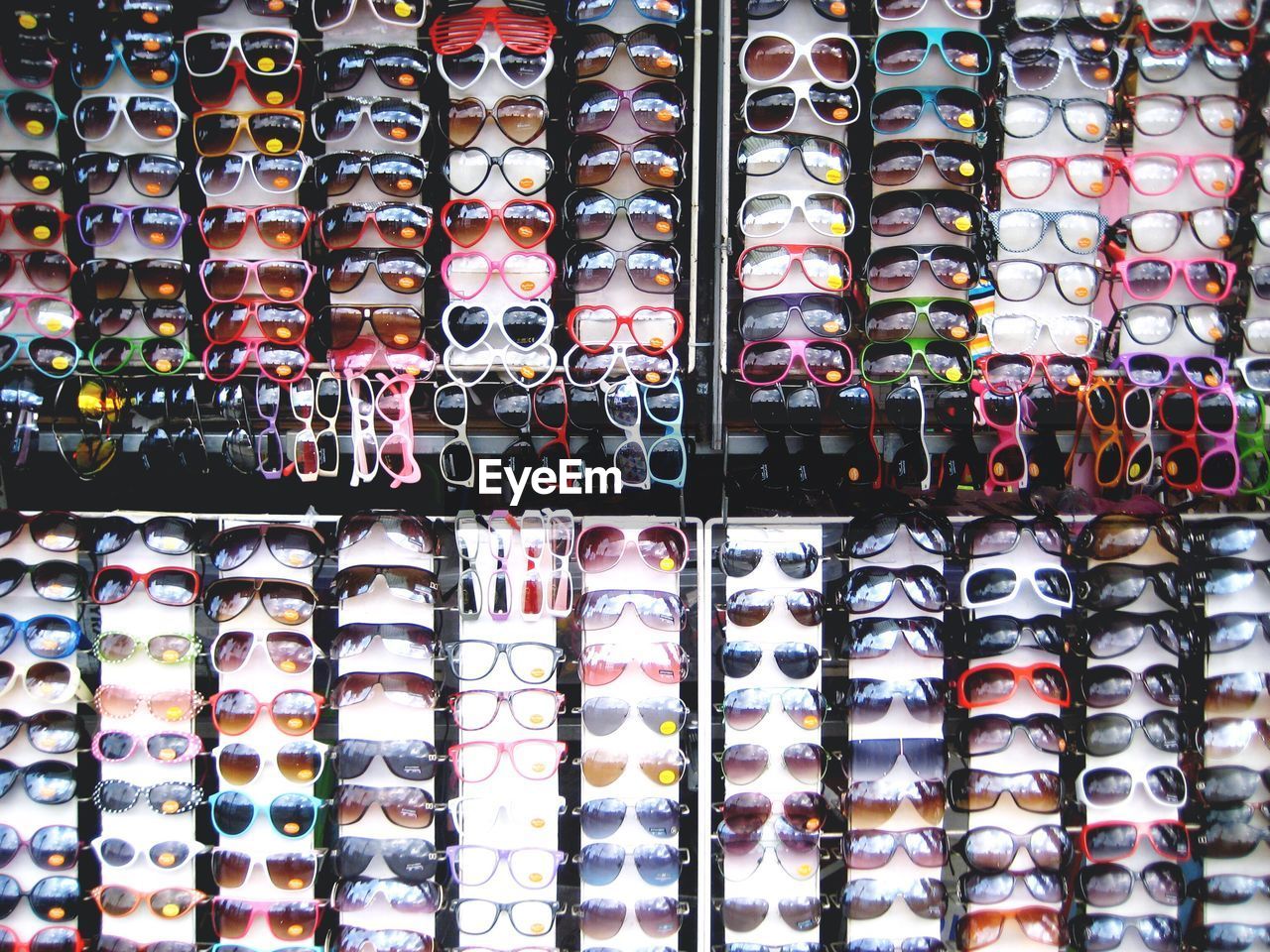 Full frame shot of colorful sunglasses arranged at market for sale