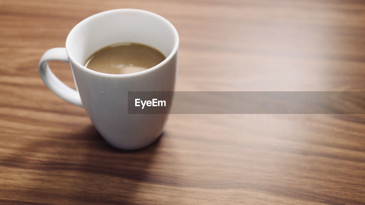 High angle view of coffee cup on table with copy space 