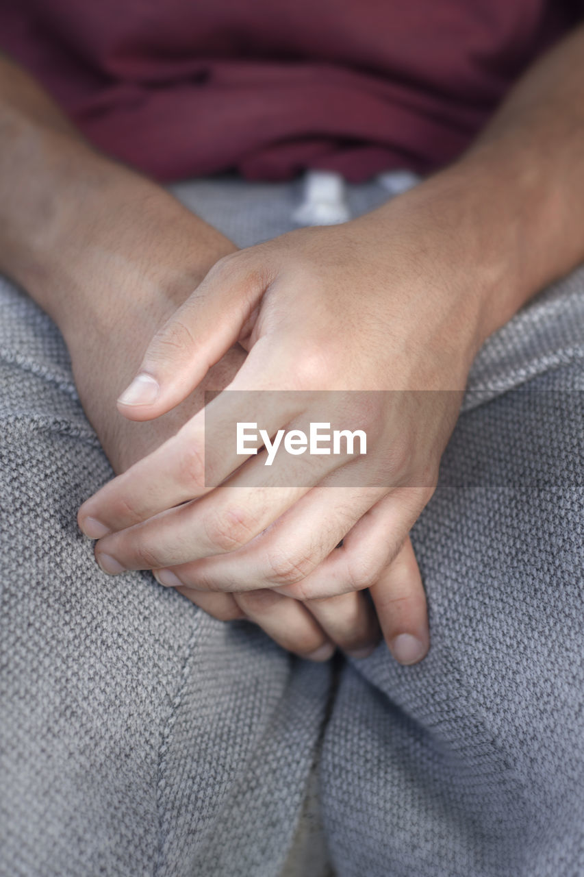 MIDSECTION OF WOMAN WITH HANDS AND LEGS