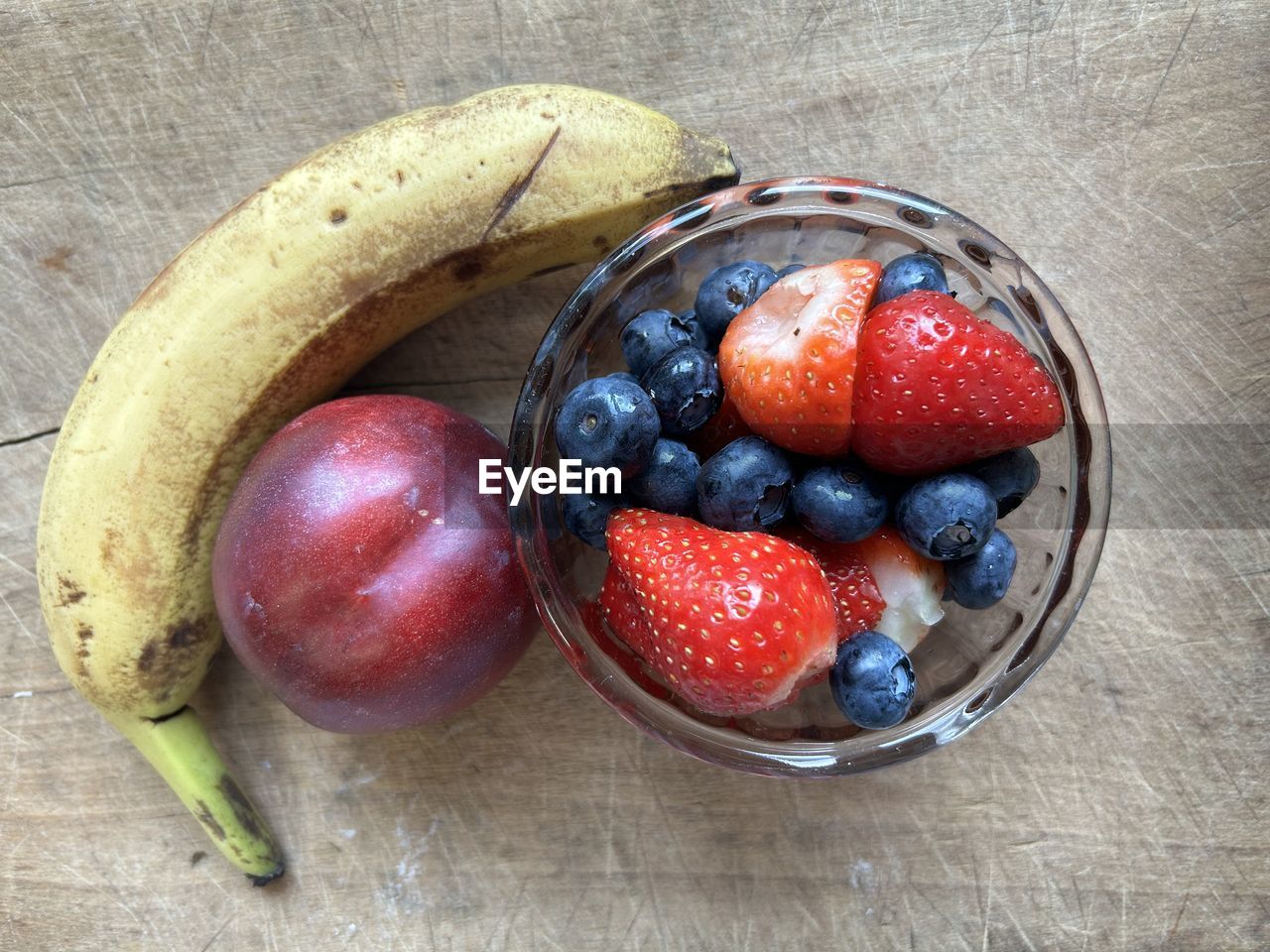 food, food and drink, healthy eating, fruit, freshness, wellbeing, berry, plant, produce, strawberry, bowl, high angle view, directly above, still life, indoors, table, no people, blueberry, red, banana, wood, breakfast, close-up, container, meal, ripe