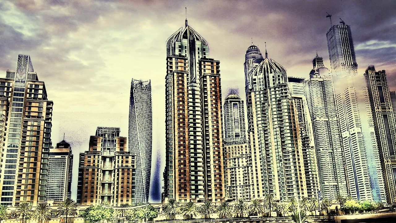 LOW ANGLE VIEW OF MODERN BUILDINGS AGAINST CLOUDY SKY