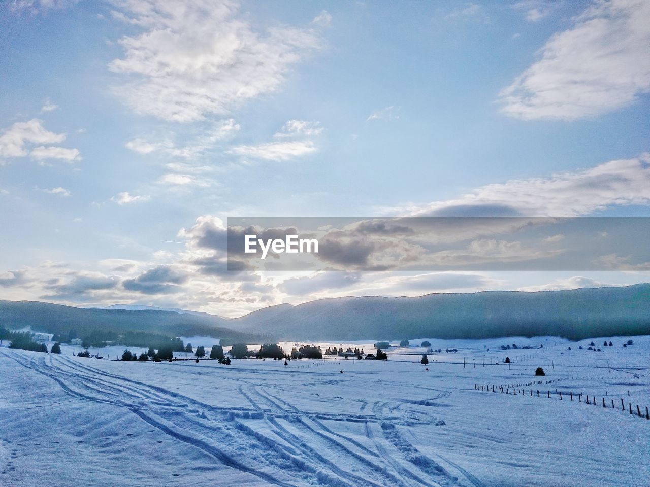 Scenic view of mountains against cloudy sky