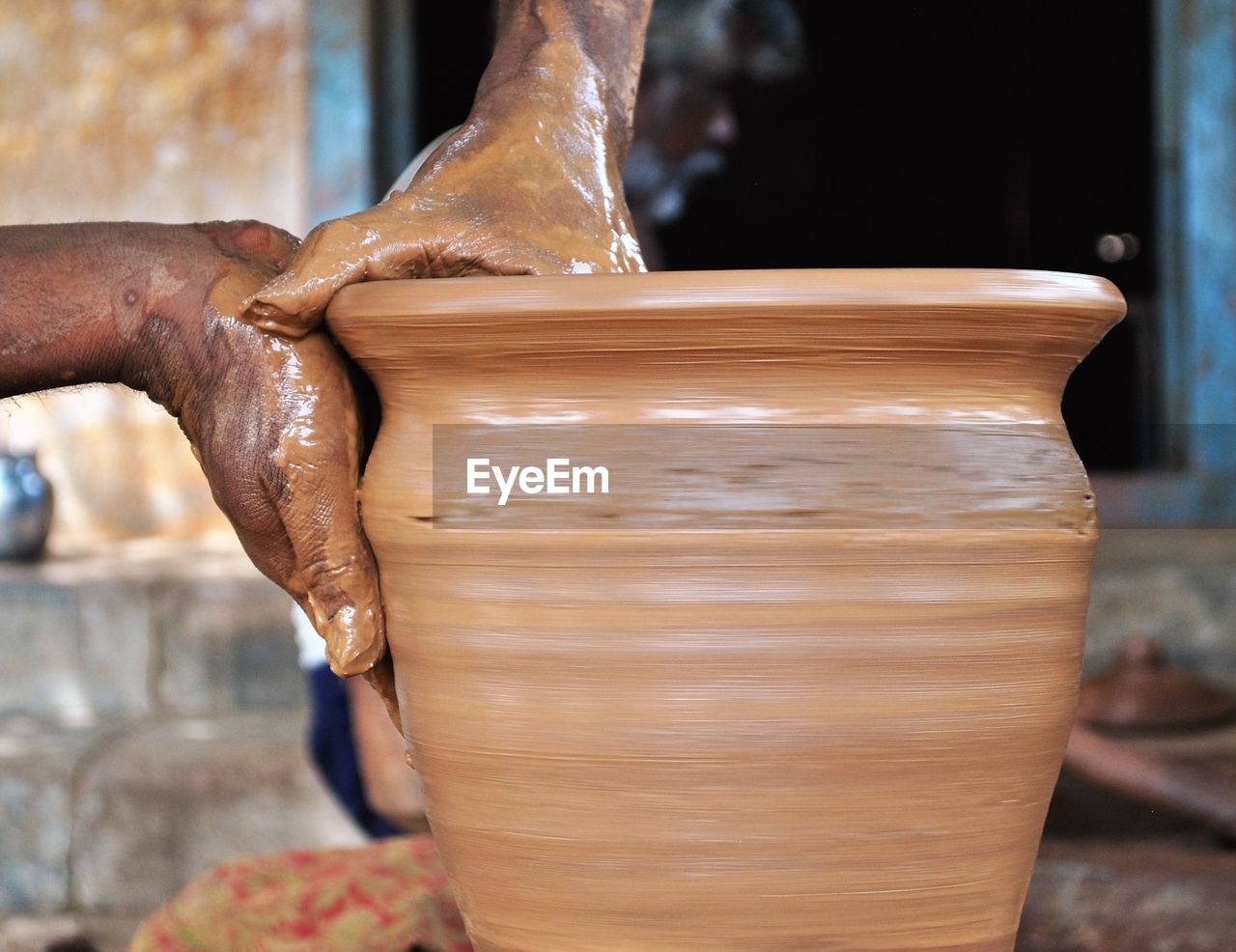 Cropped image of craftperson making pottery