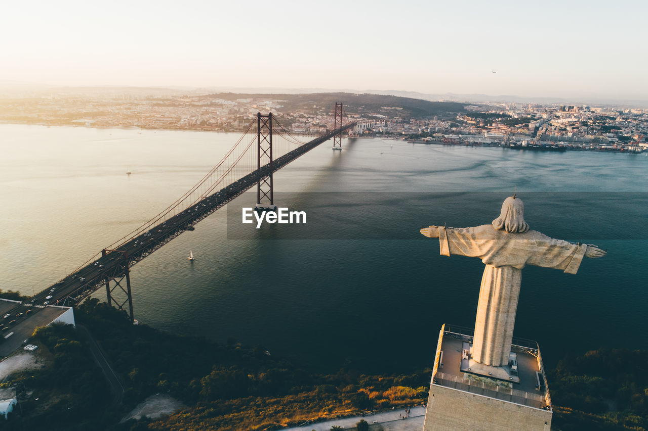 Drone fly by city of lisbon almada and famous 25th april bridge over river tagus 