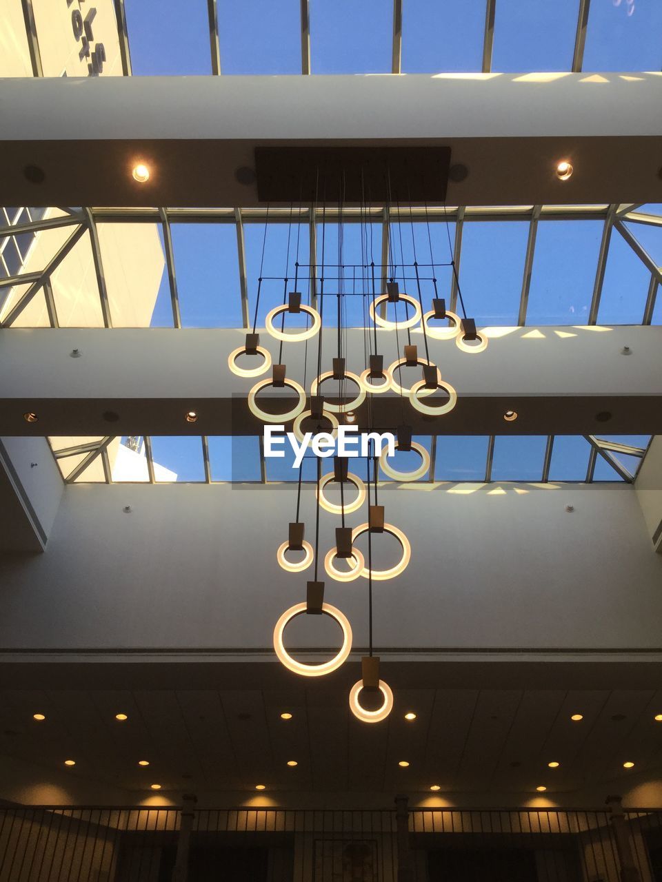 LOW ANGLE VIEW OF ILLUMINATED LIGHT HANGING ON CEILING