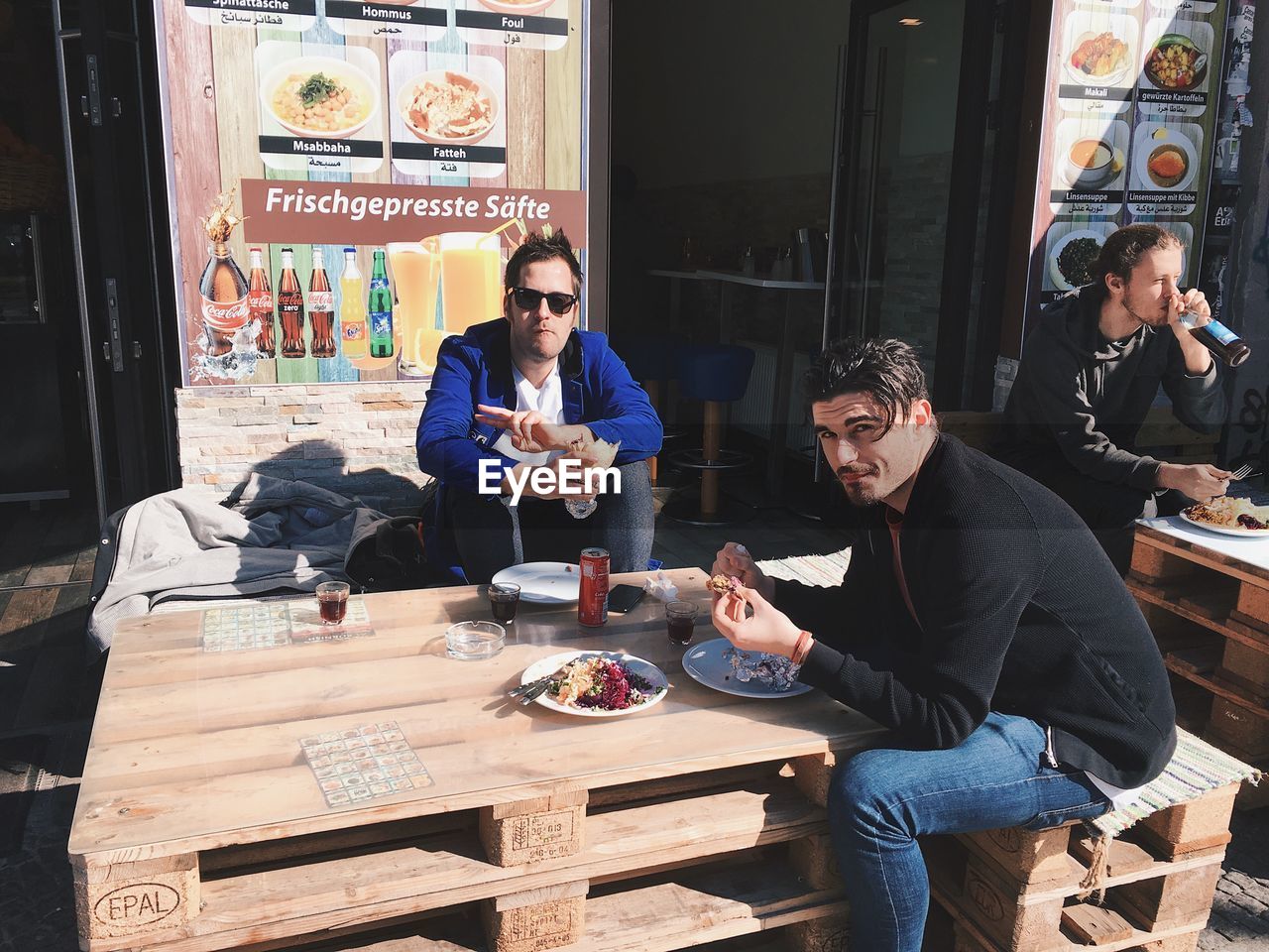 YOUNG MAN AND WOMAN SITTING AT TABLE