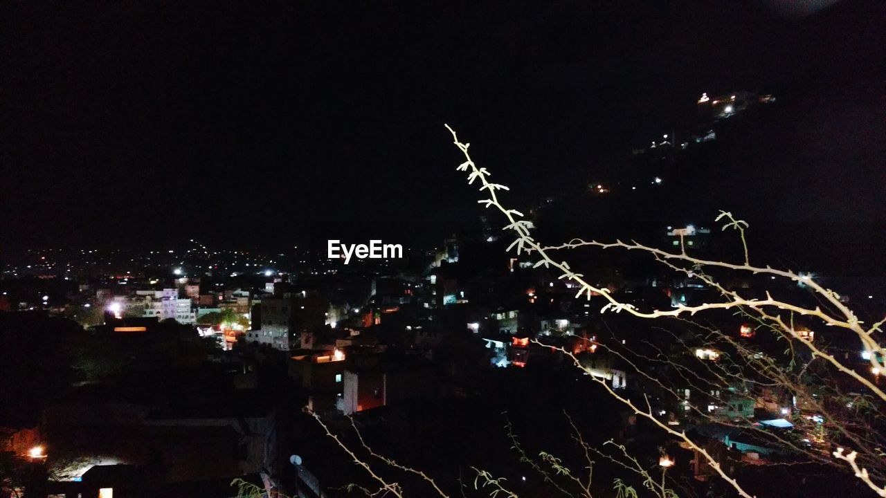 VIEW OF ILLUMINATED CITYSCAPE AT NIGHT