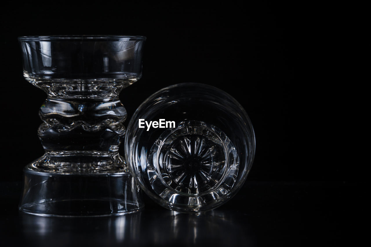 Close-up of glass bowls against black background