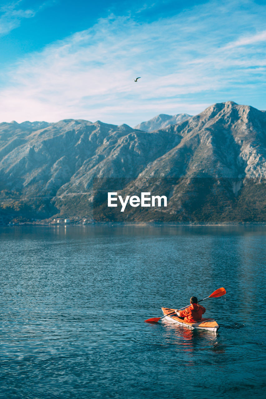 SCENIC VIEW OF LAKE AGAINST MOUNTAIN