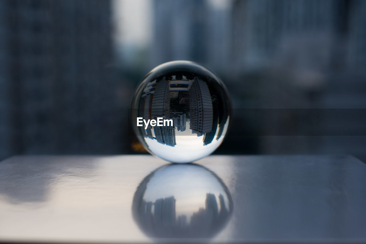 CLOSE-UP OF CRYSTAL BALL WITH REFLECTION OF CAMERA