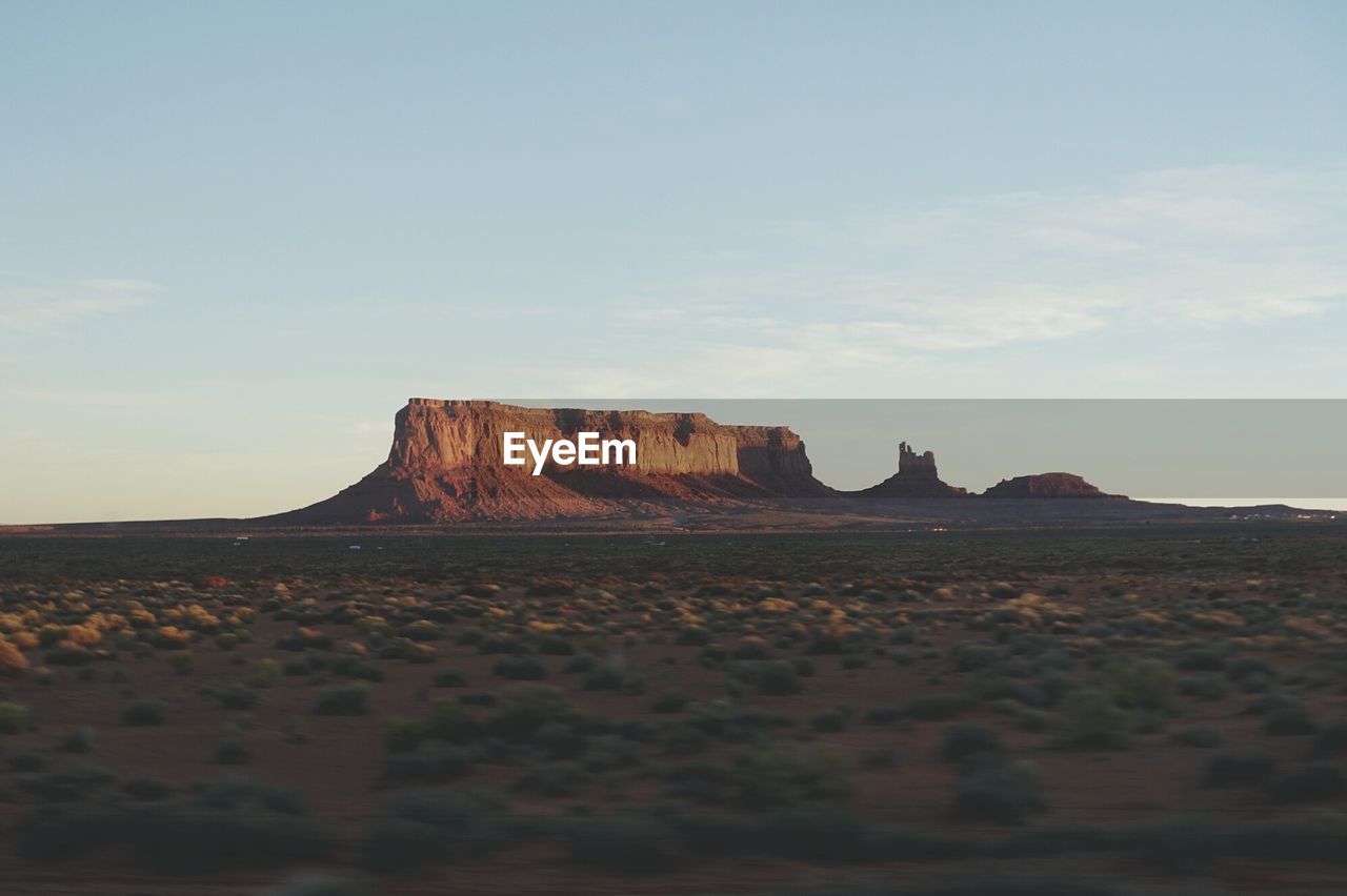 Landscape by rock formations against sky