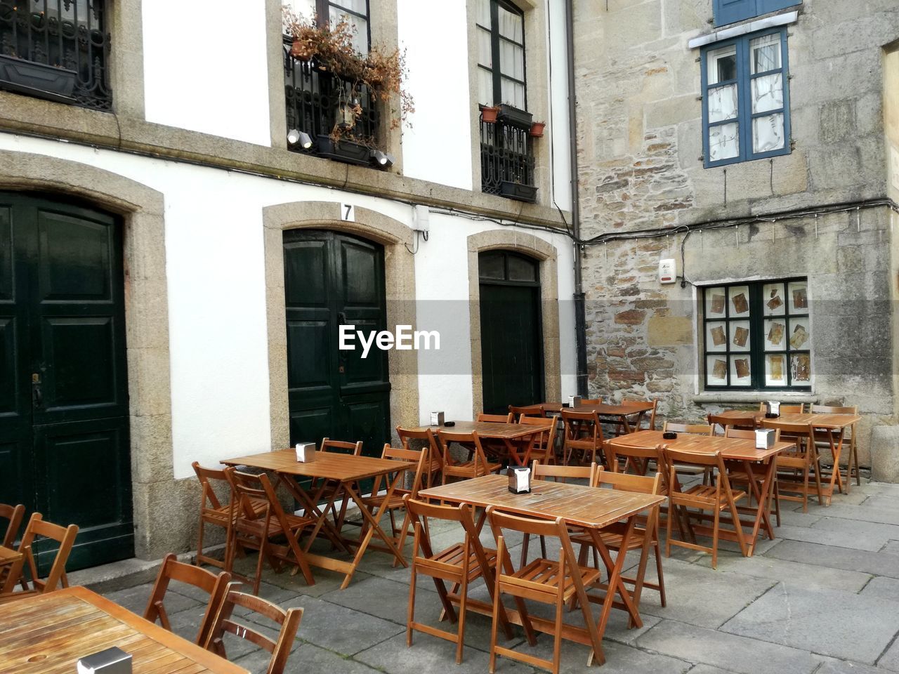 EMPTY CHAIRS AND TABLE IN CAFE