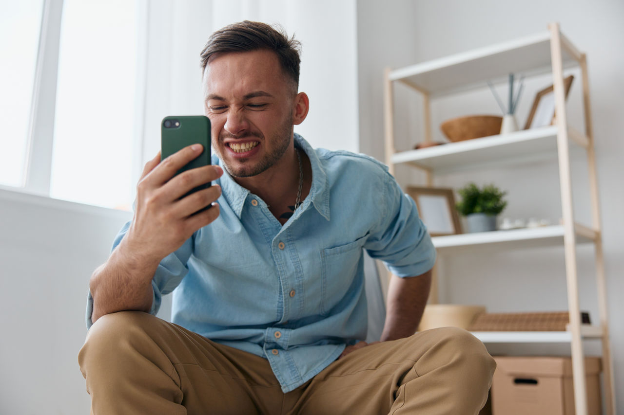 young woman using mobile phone while sitting at home