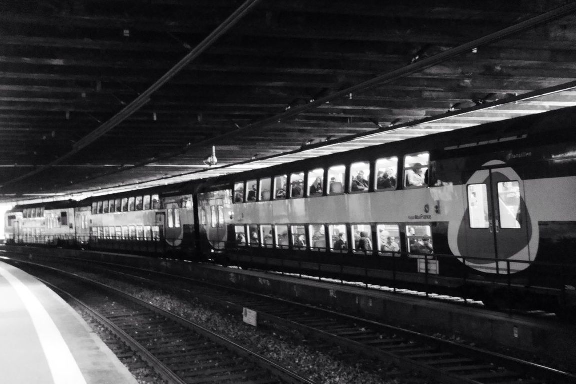 TRAIN ON RAILROAD STATION PLATFORM