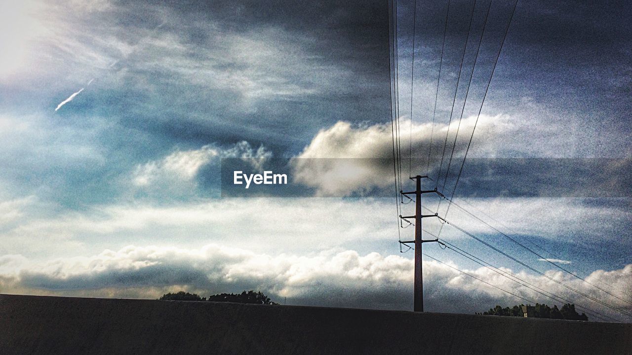 LOW ANGLE VIEW OF ELECTRICITY PYLONS