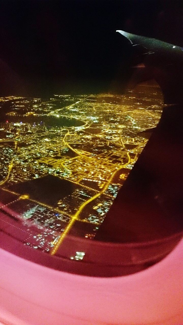 AERIAL VIEW OF ILLUMINATED CITYSCAPE AT NIGHT