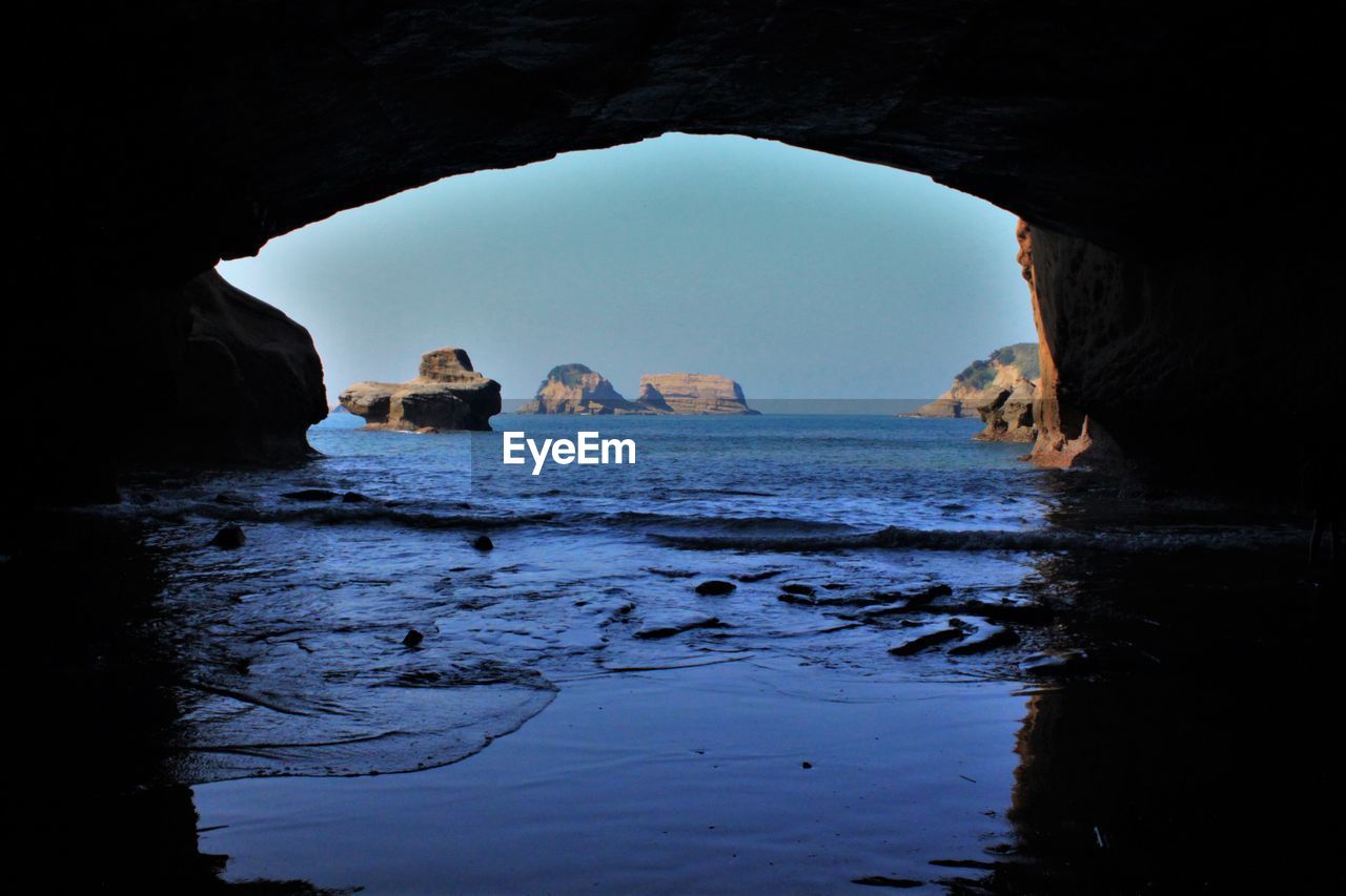 Scenic view of sea seen through cave