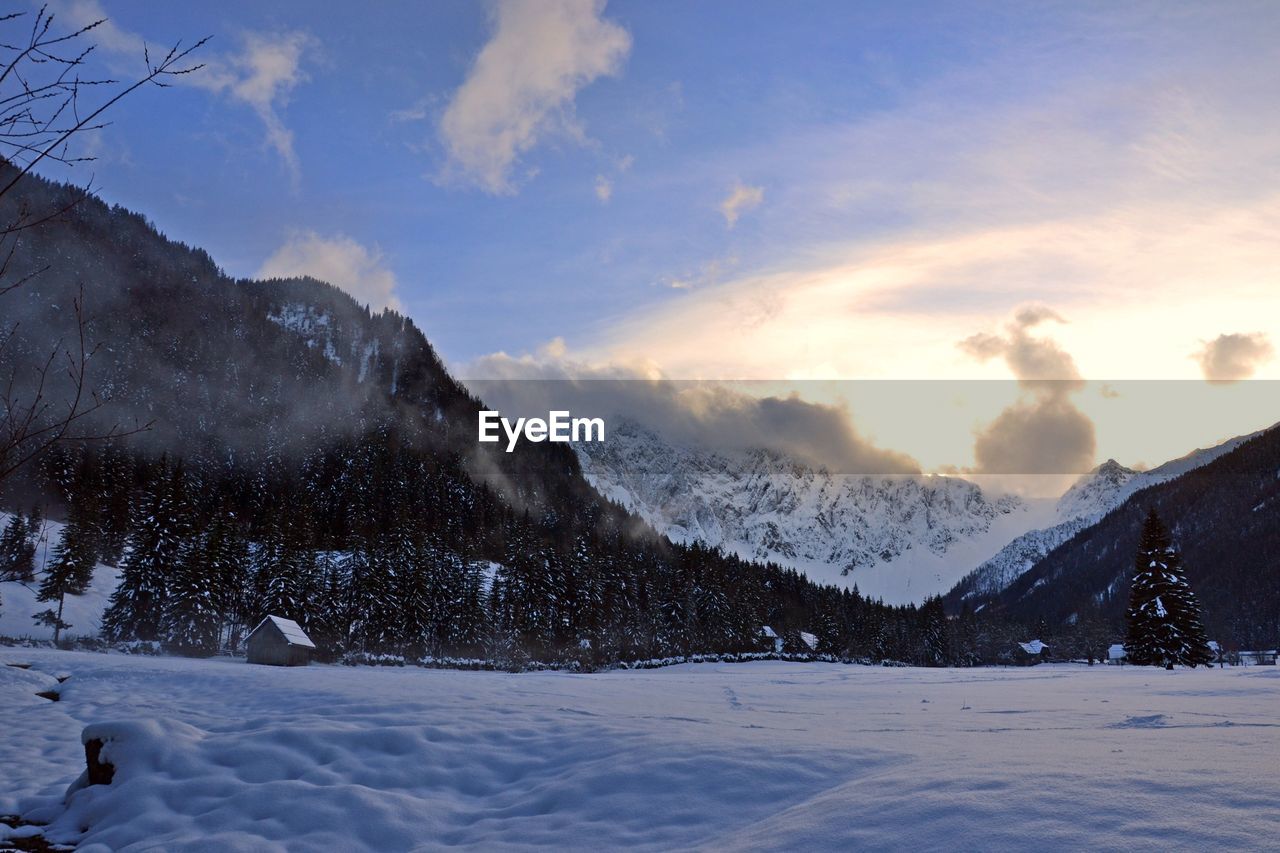 SNOW COVERED LANDSCAPE AGAINST SKY