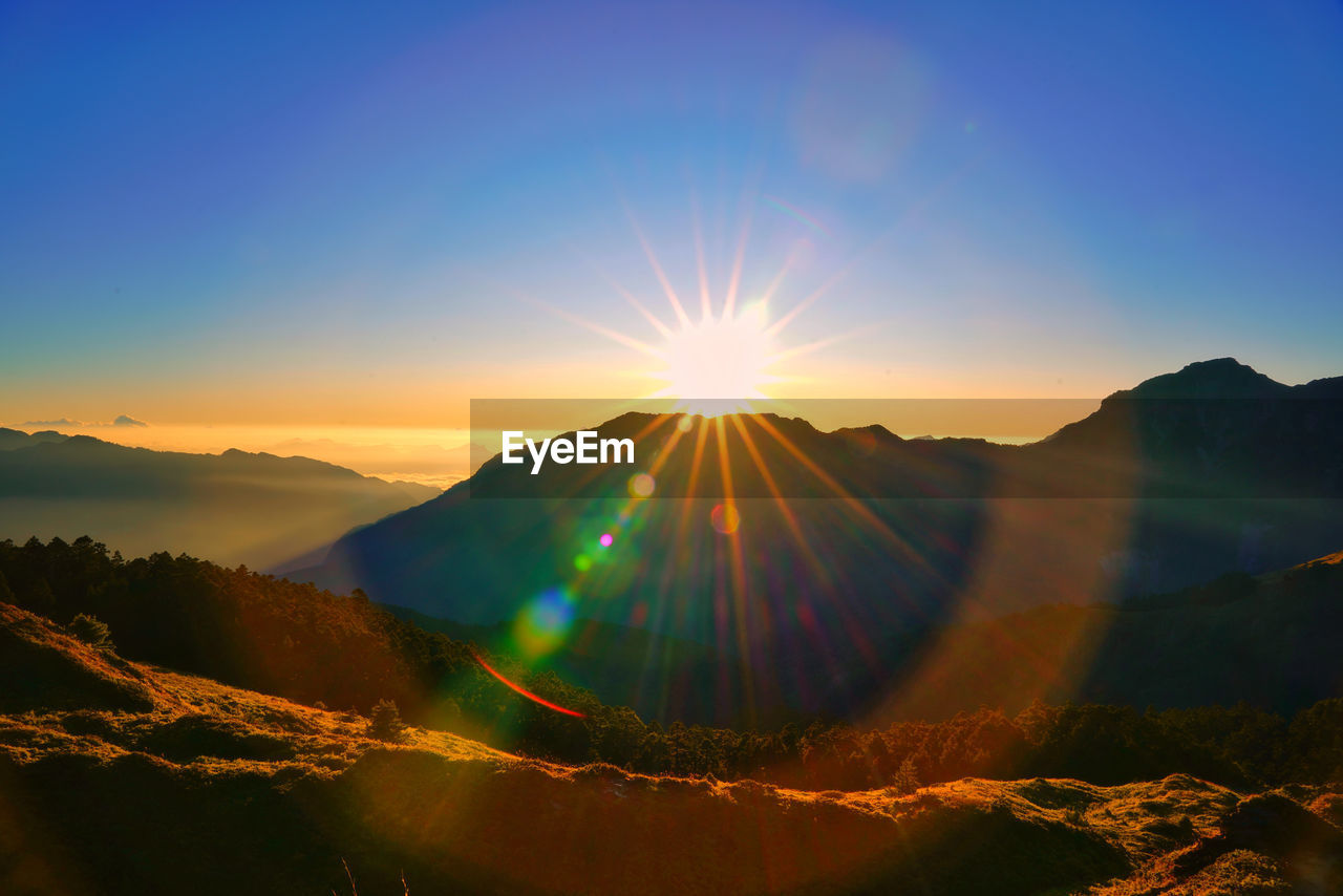 Scenic view of mountains against sky during sunset