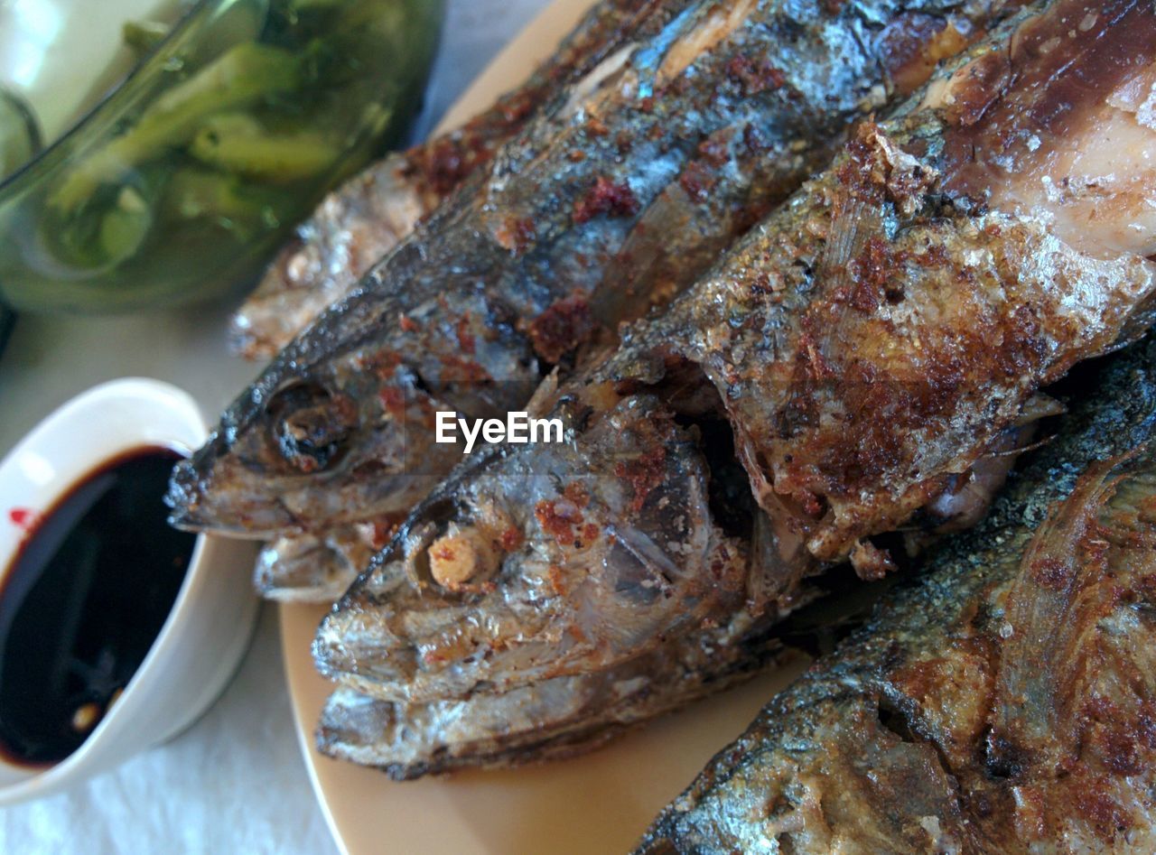 High angle view of fresh fried fish served in plate on table at restaurant