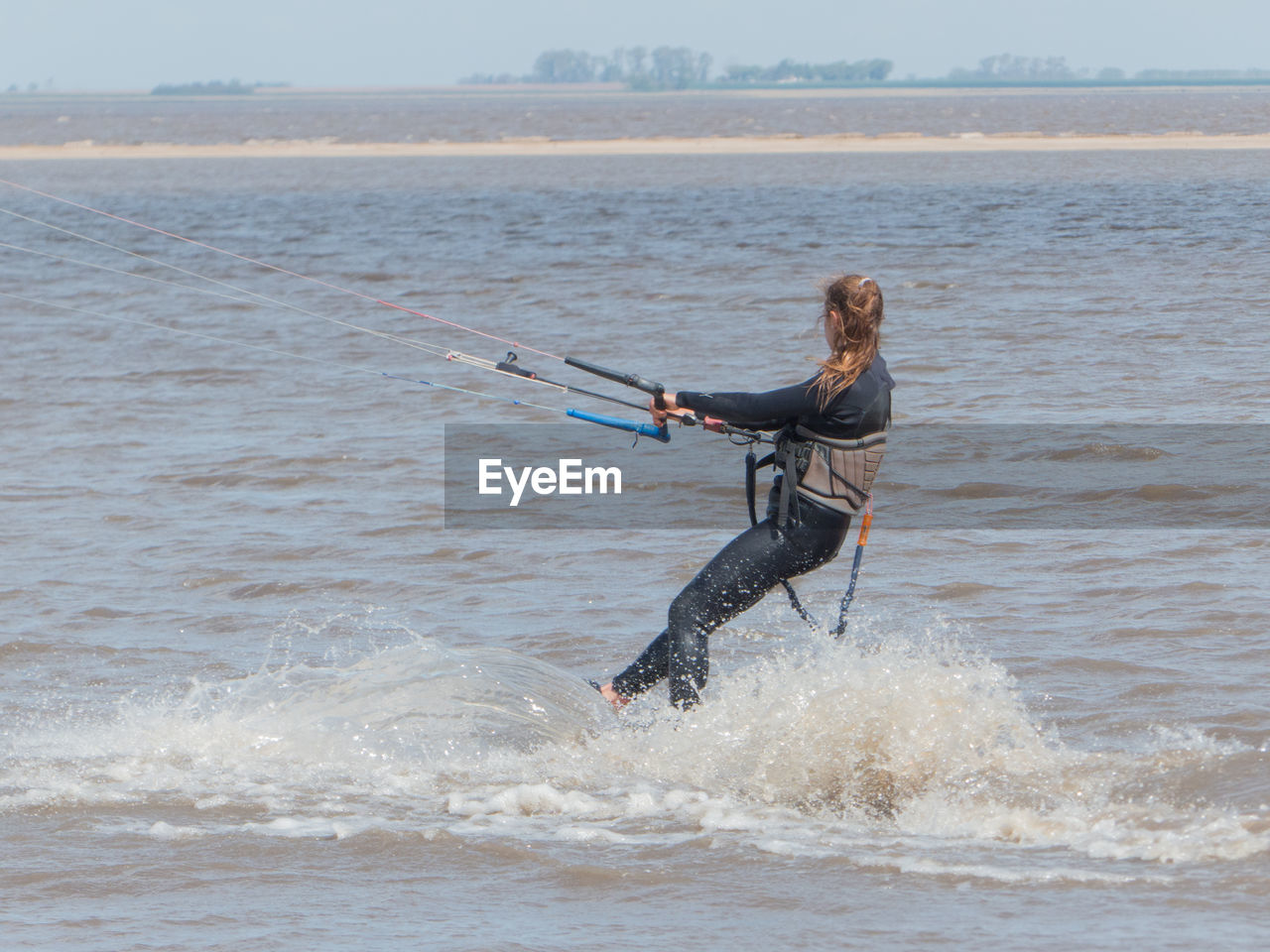 Full length of woman surfing on sea