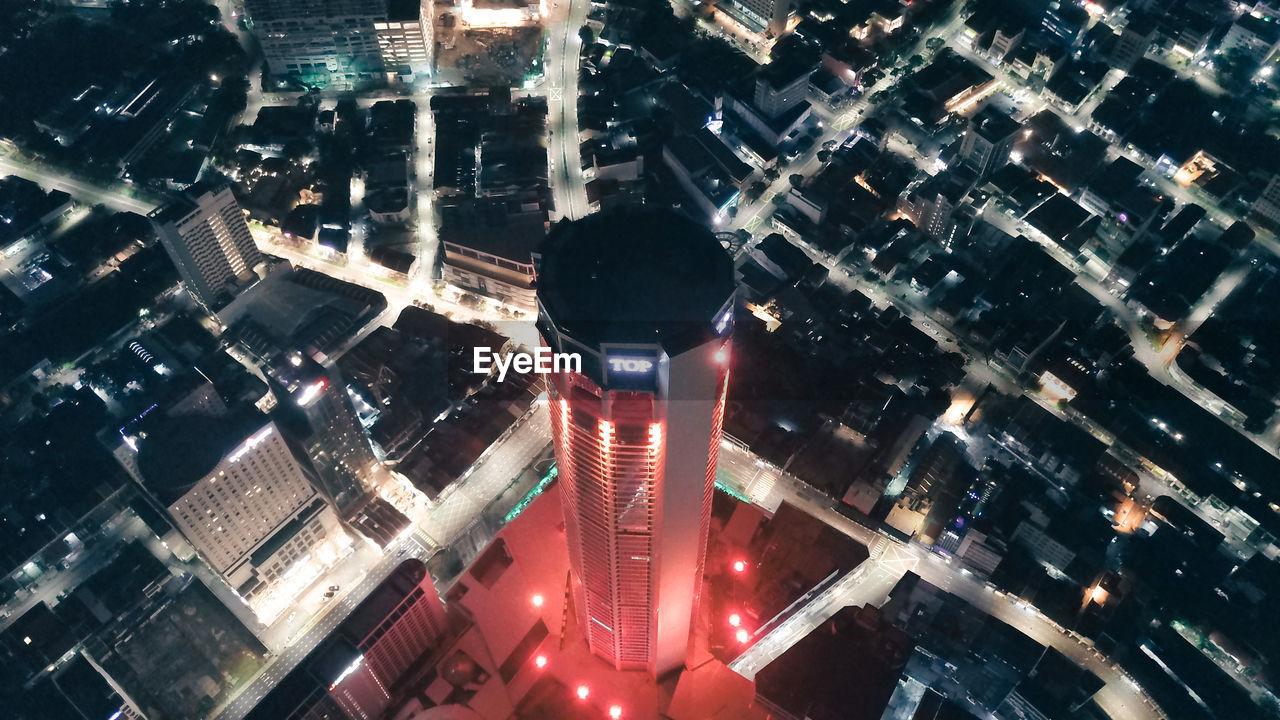 HIGH ANGLE VIEW OF ILLUMINATED MODERN BUILDINGS IN CITY