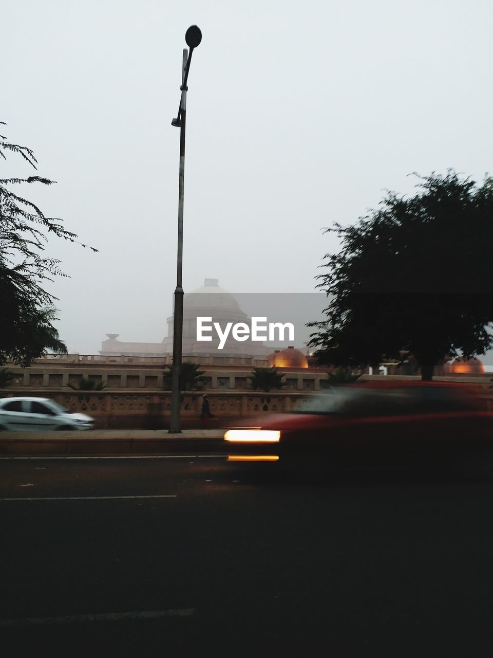 CAR ON STREET AGAINST SKY