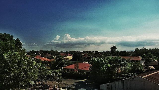 RESIDENTIAL BUILDINGS AGAINST CLOUDY SKY