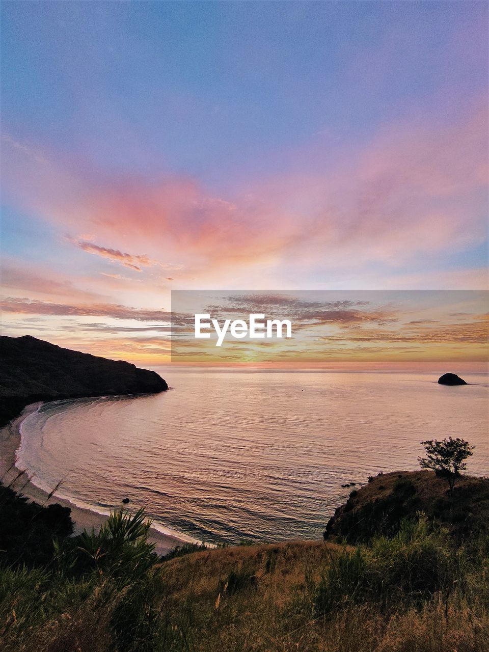Stunning sunset on a hilltop at anawangin cove, zambales, philippines