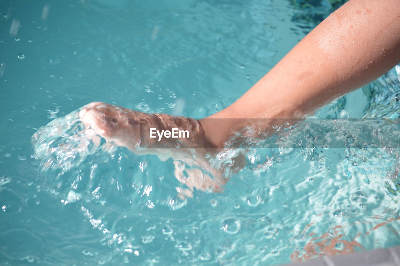 Low section of woman in swimming pool