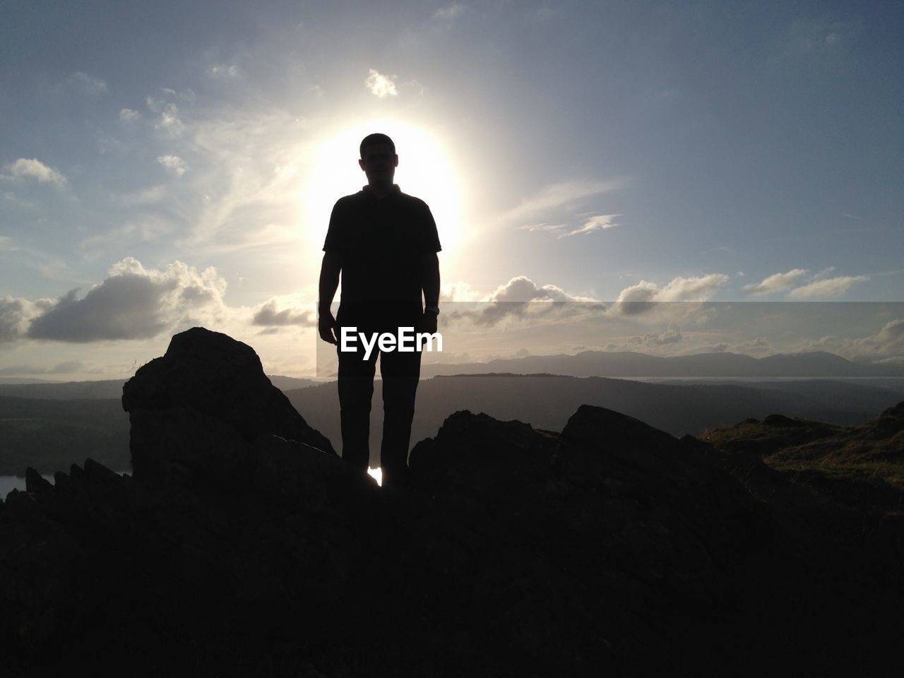 Silhouette of hiker looking at mountains