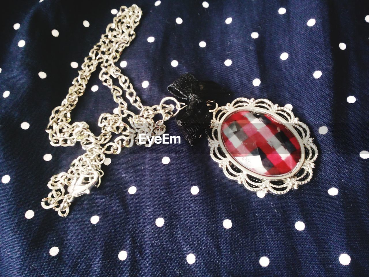 Necklace with checkered pattern pendant in detail