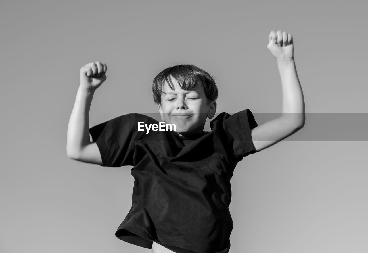 Portrait of boy jumping against white background