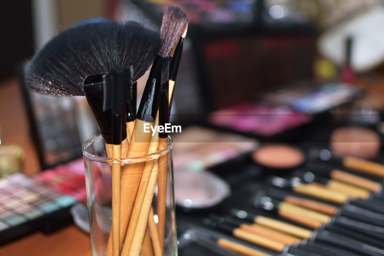 Close-up of make-up brushes in container