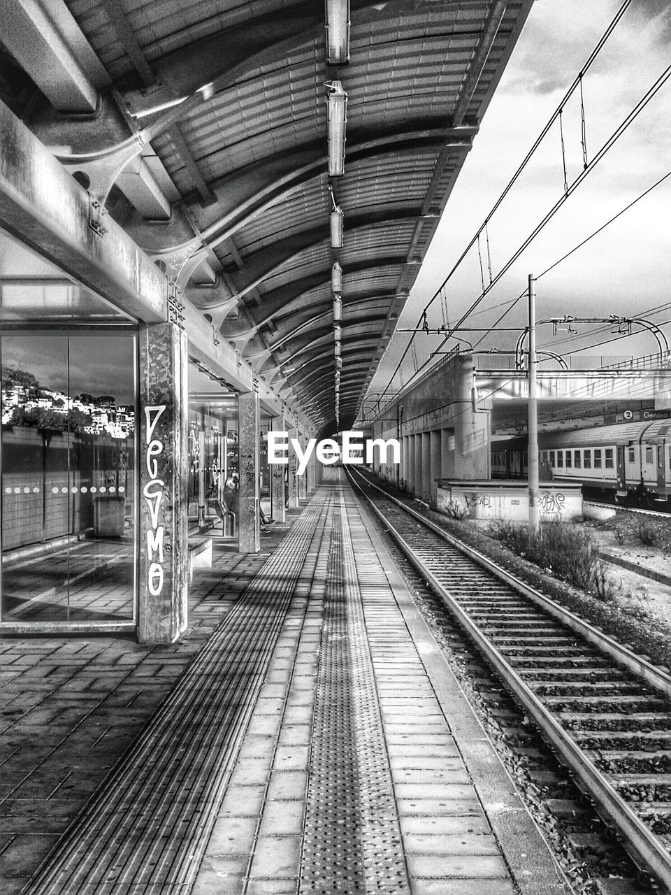 RAILROAD TRACKS ON RAILROAD STATION PLATFORM