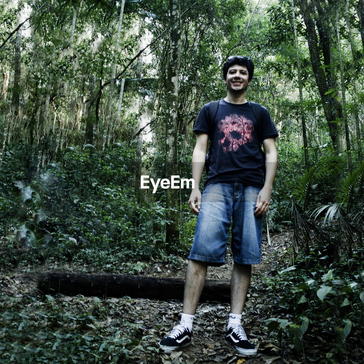 Portrait of man standing in forest