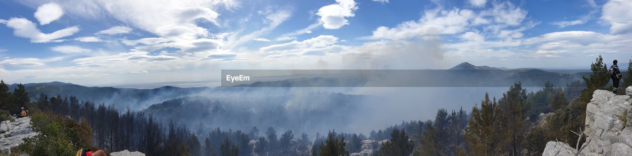 Panoramic view of forest fire from ridge above