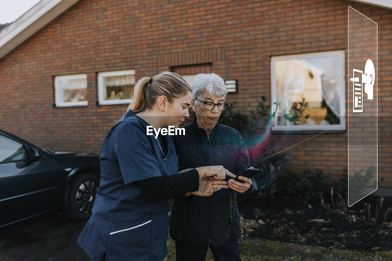 Young woman showing older woman fake news