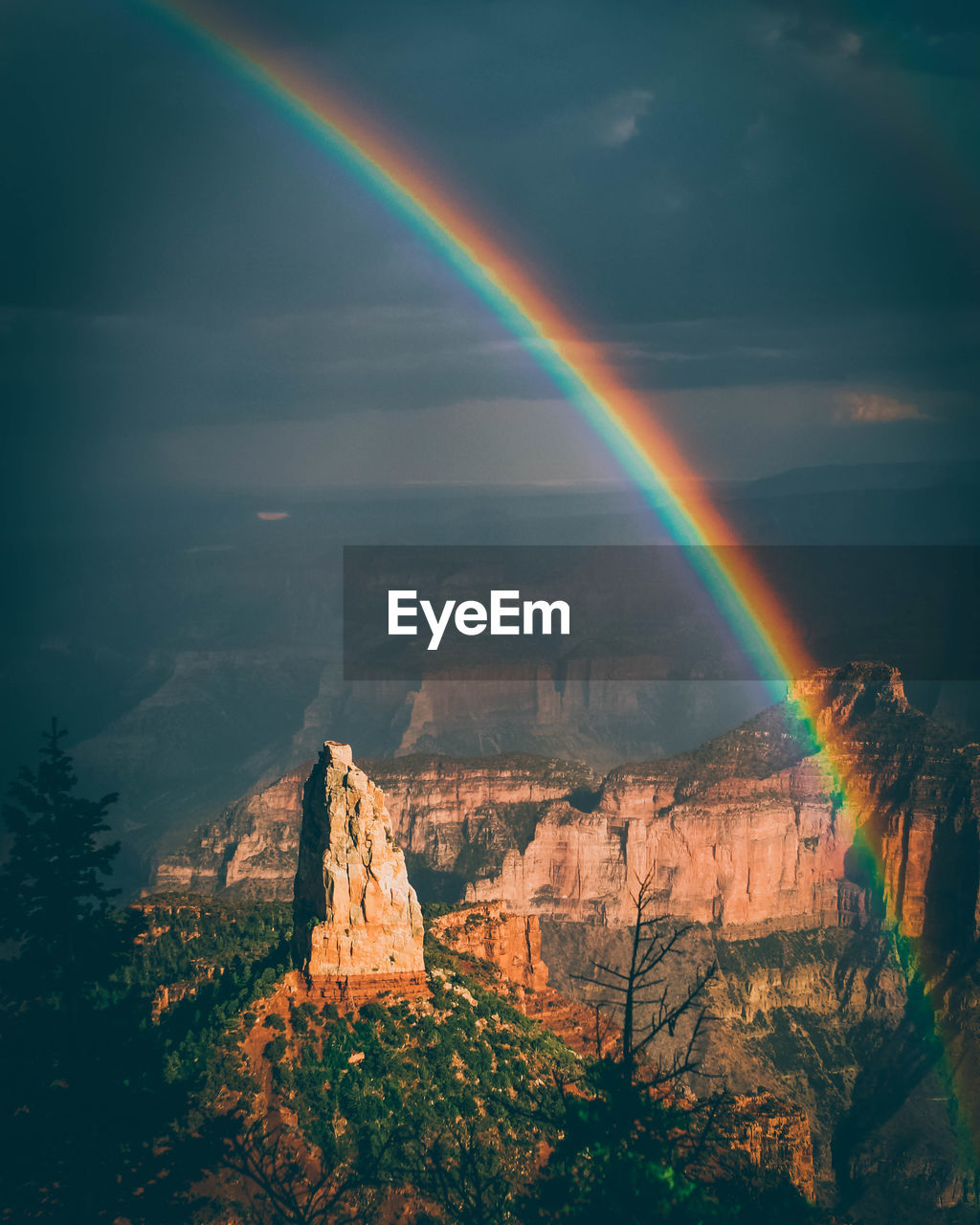 Scenic view of rainbow over rocks