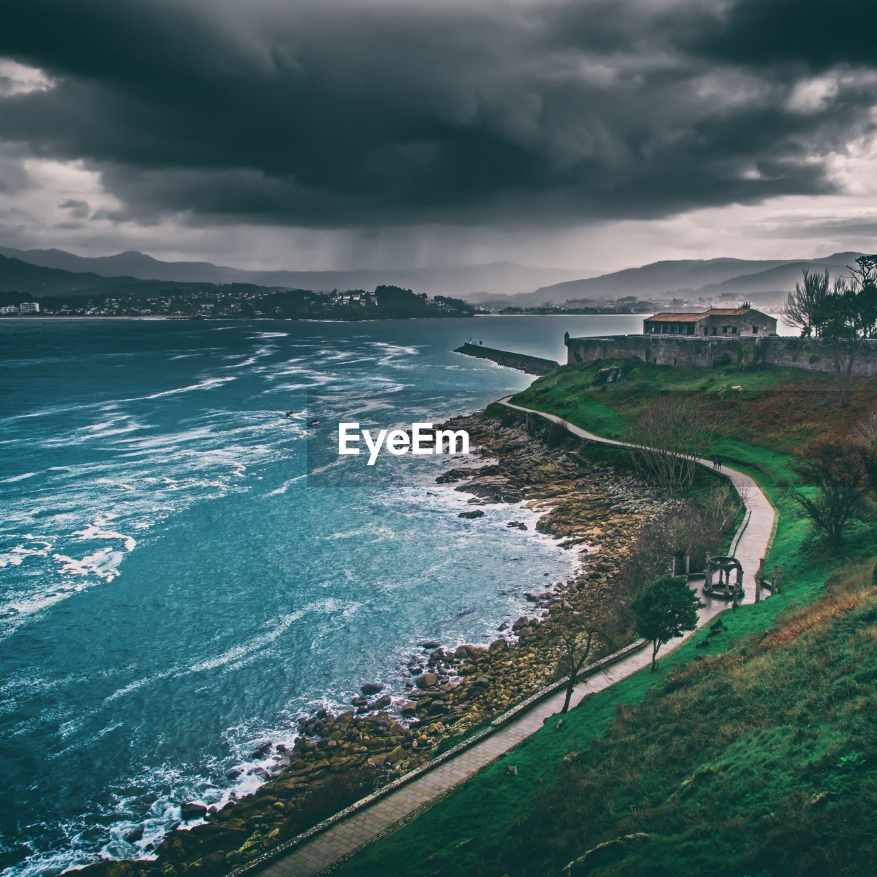 Aerial view of landscape by sea against sky